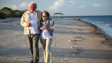 Senior couple walking on beach