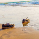 Empty shoes by the sea