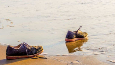 Empty shoes by the sea