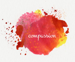 Watercolor splashes with the word Compassion written